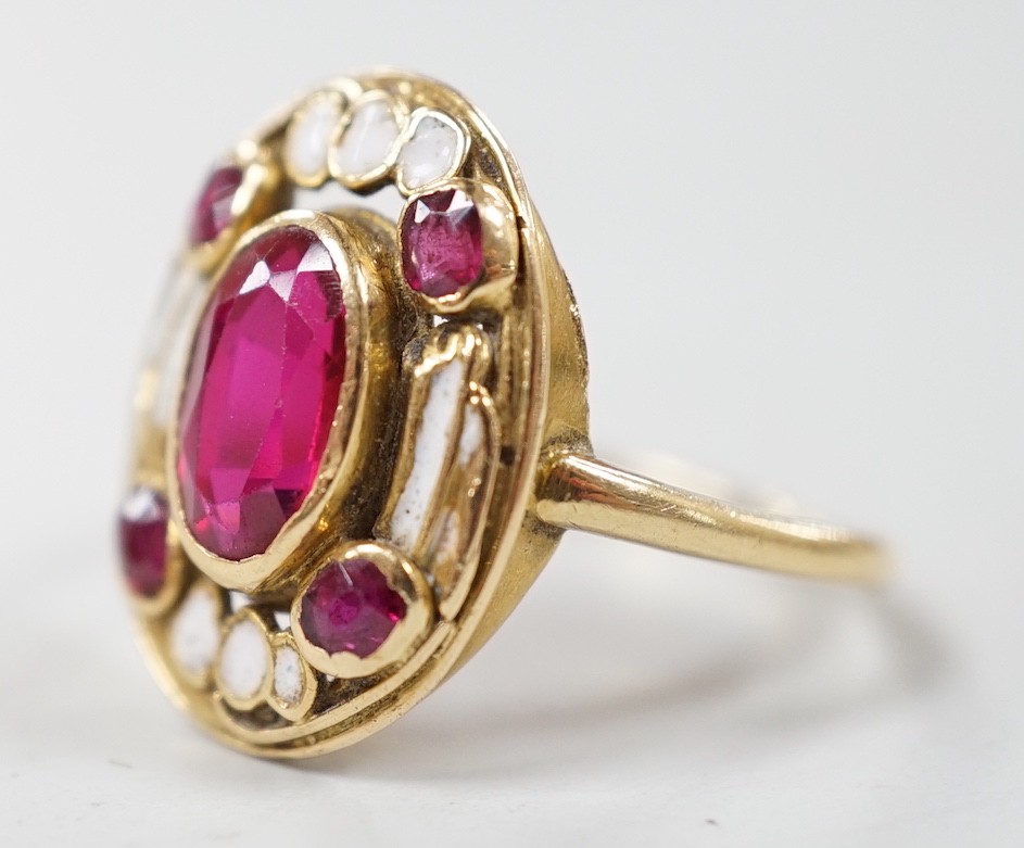 An 18ct, white enamel and four stone synthetic? ruby set oval dress ring, size N, gross weight 3.9 grams.